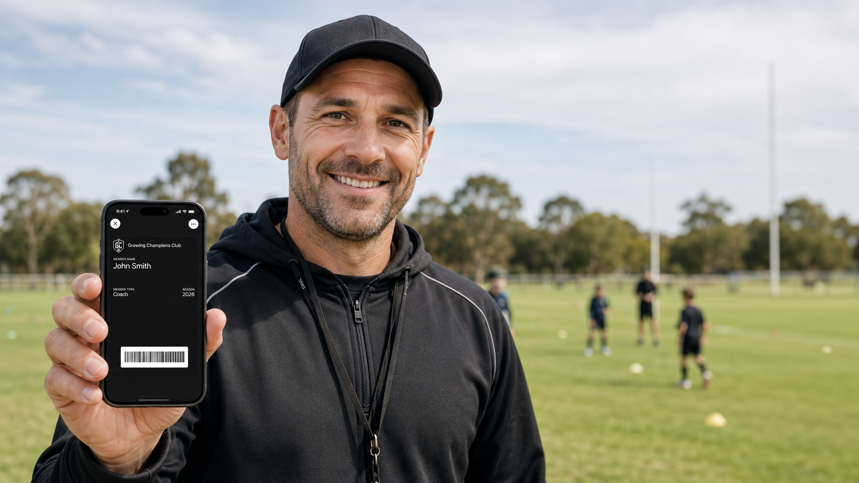 Grassroots coach showing a Growing Champions digital membership card on their phone